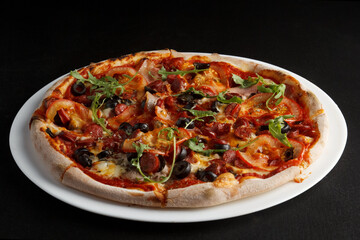 fragrant and hot pizza on a dark background
