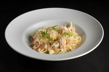 pasta carbonara on a black background