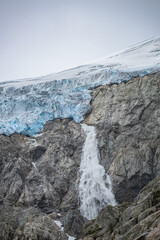 Waterfall comes out of a glacier in Norway