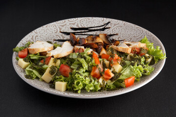Delicious and healthy salad on a dark background