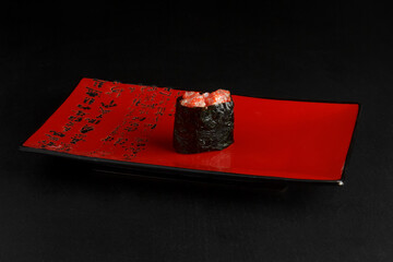 Asian cuisine dish, delicious sushi, sushi on a black background, roll you net on a black background