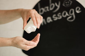 Hands Holding Massage Oil: Essential for Nurturing Baby's Skin and Well-Being 