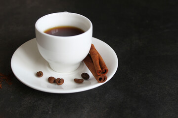 Coffee cup and saucer on a wooden table. Dark background
