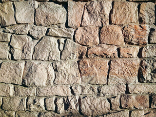Masonry stone wall texture. Stones in the foundation. Stone wall background for design or illustration