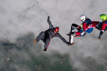 Team of skydivers perform acrobatics mid-air
