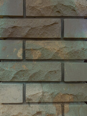 Solid piece of beige brick wall. brickwork for background or texture, dark spots on brickwork