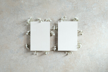 Set of wedding invitation cards mockups decorated flowers. Flat lay, top view. Minimal style.