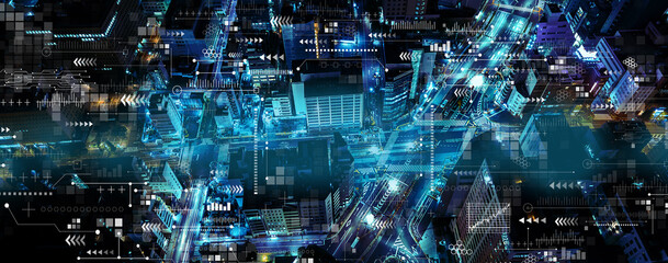 Technology screen with aerial view of urban city at night