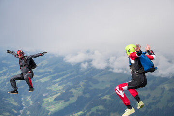 Team of skydivers perform acrobatics mid-air