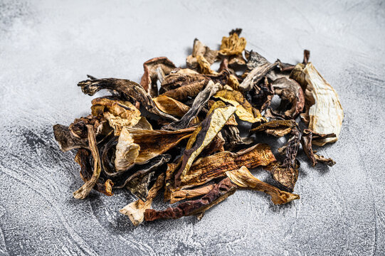 Mixed wild dried mushrooms. White background. Top view