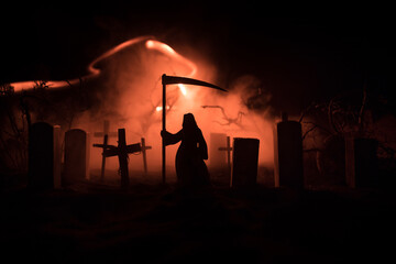 Scary view of zombies at cemetery dead tree, moon, church and spooky cloudy sky with fog, Horror Halloween concept with glowing pumpkin. Selective focus