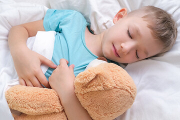boy sleeping sweetly hugging a toy