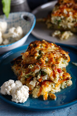 Cauliflower with carrots, peas and bechamel sauce.