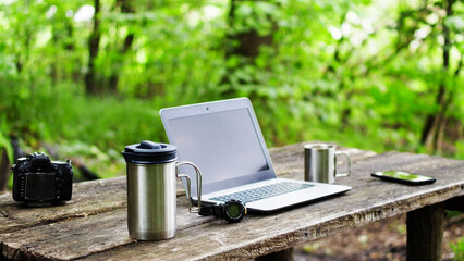 Computer Coffee Mug and Telephone on black wood table.