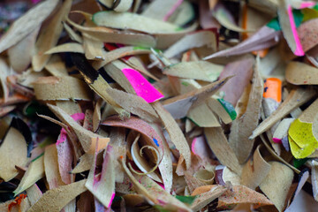 Shavings of colored pencils on a white background. Macro shooting.