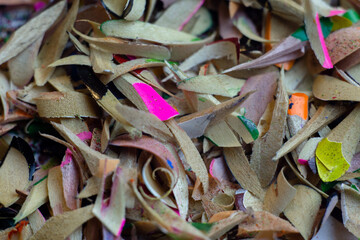 Shavings of colored pencils on a white background. Macro shooting.