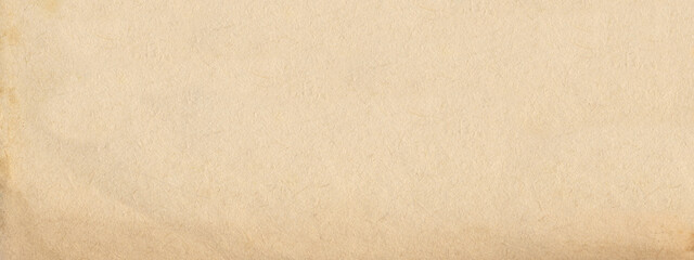 Old paper vintage brown or beige retro design background with damaged, weathered dirty surface. A rustic grungy textured material like a blank horizontal parchment page, an empty manuscript texture