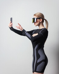 android female in VR glasses and mobile phone on white background.