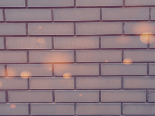 A solid piece of gray brick wall. brickwork for background or texture, colored highlights of light on brickwork