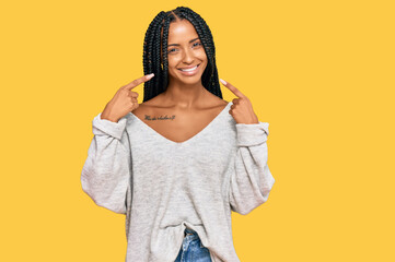 Beautiful hispanic woman wearing casual clothes smiling cheerful showing and pointing with fingers...