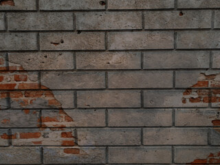 A solid piece of brown brick wall. brickwork for the background or texture, sometimes the brickwork is destroyed