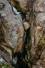 Canyon with a steep rock face and small creek