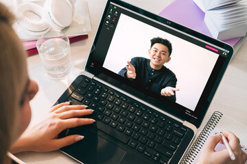 Video conference. Web chat. Remote job. Pandemic WFH. Woman listening Asian male colleague speech...