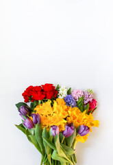 Bright bouquet of spring flowers on white background.