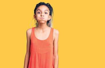 Cute african american girl wearing casual clothes puffing cheeks with funny face. mouth inflated...