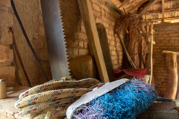 Old hand saw resting on a brick wall of a farm