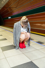 Young woman with blonde hair in the metro