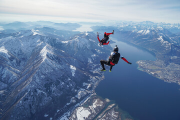 Skydivers perform stunts over Swiss Alps