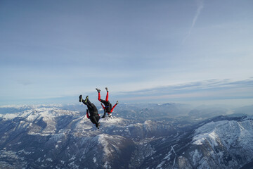 Naklejka na ściany i meble Skydivers perform stunts over Swiss Alps