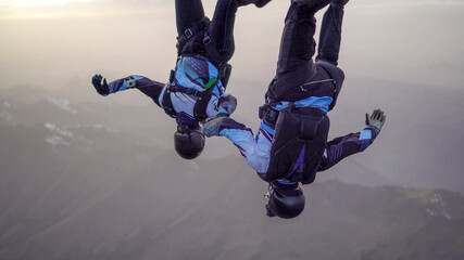Skydivers perform stunts over Swiss Alps