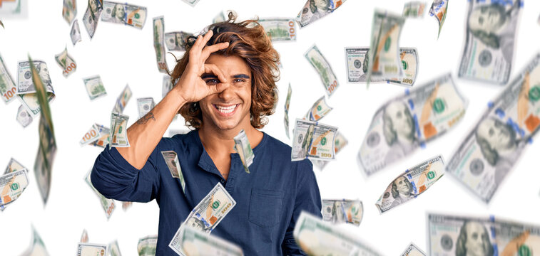 Young hispanic man wearing casual clothes doing ok gesture with hand smiling, eye looking through fingers with happy face.