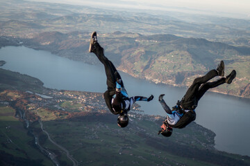 Skydivers perform stunts over Swiss Alps