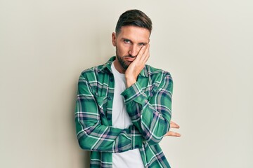 Handsome man with beard wearing casual clothes thinking looking tired and bored with depression problems with crossed arms.