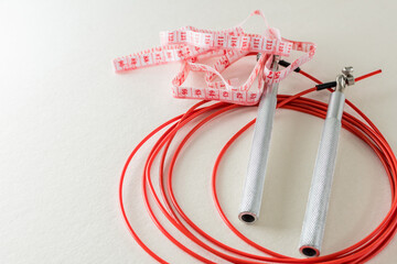 Measuring tape, jump rope, top view. Fitness and workout concept.