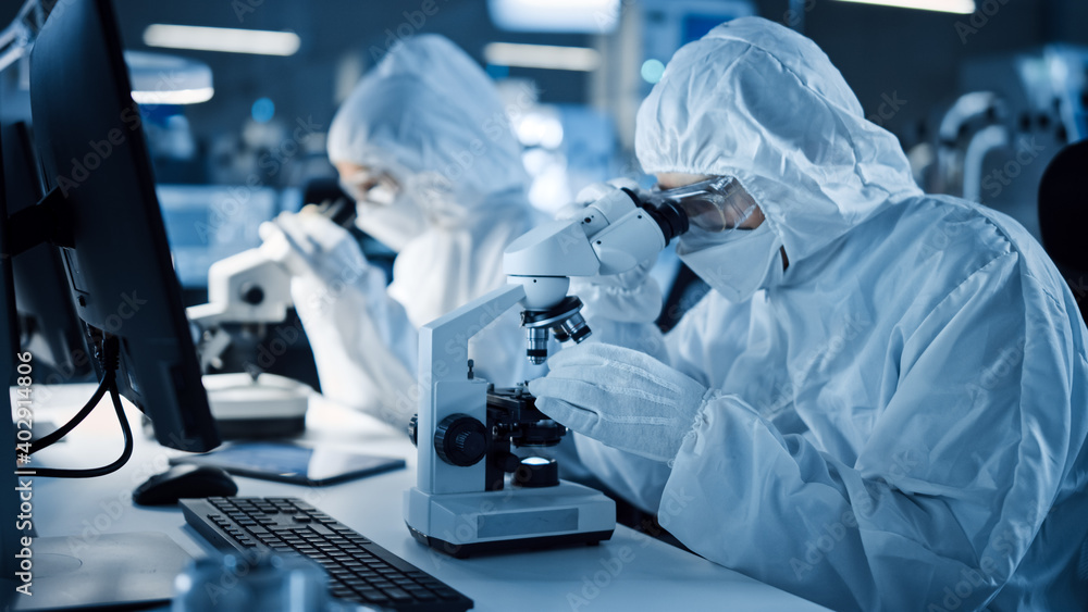 Aufkleber Research Factory Cleanroom: Engineers / Scientists wearing Coveralls and Gloves Use Microscopes to Inspect Motherboard Microprocessor Components, Developing High Tech Modern Electronics