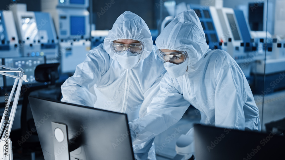 Poster Research Factory Cleanroom: Engineer and Scientist Wearing Coveralls Talk and Work on Computer, Use Microscope to Inspect Motherboard Microprocessor, Develop Electronics for Medical Electronics
