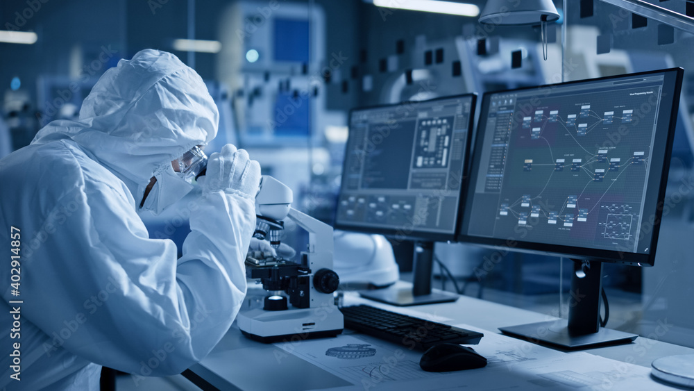 Poster research factory cleanroom: engineer / scientist wearing coverall and gloves use microscope to inspe