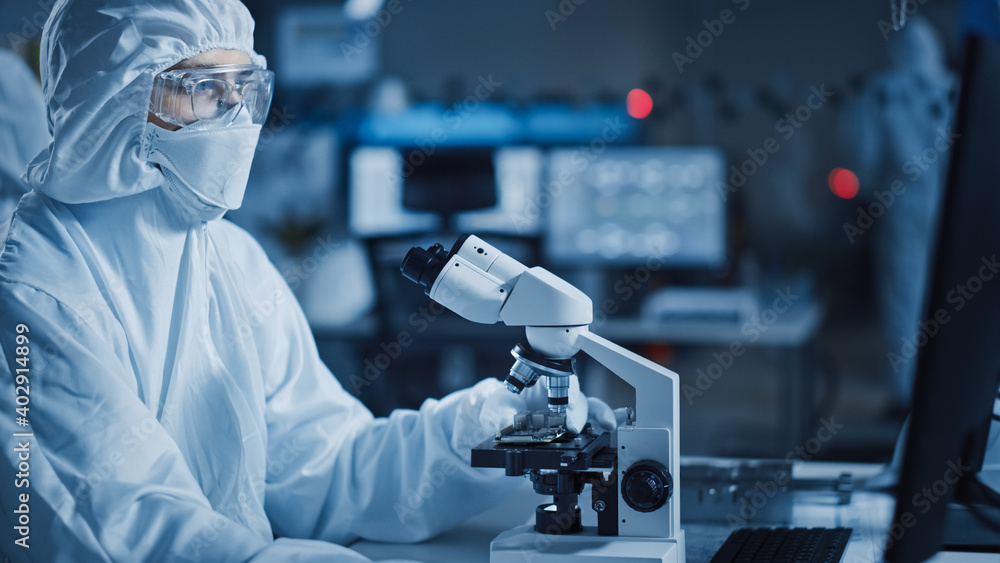 Poster Research Factory Cleanroom: Engineer / Scientist wearing Coverall and Uses Microscope to Inspect Samples, Developing High Tech Modern Technology for Medical and High Precision Electronics Industry