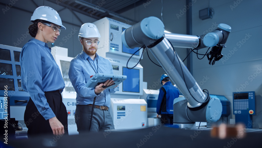 Aufkleber Factory Workshop: Professional Female Engineer, Male Machinery Operator Use Industrial Digital Tablet Computer to Work and Program Robot Arm for Production Line. High-Tech Facility with CNC Machines