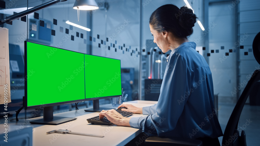 Poster factory office: portrait of beautiful and confident female industrial engineer working on personal c