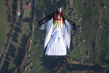 Wingsuit flier glides over Swiss Alps