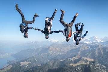 Skydivers perform stunts over Swiss Alps