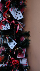 Playing cards and poker chips near a Christmas tree