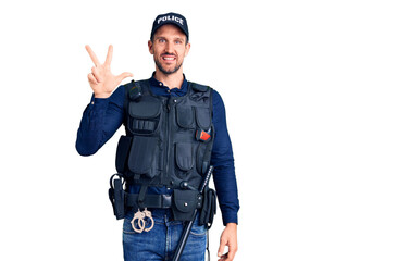 Young handsome man wearing police uniform showing and pointing up with fingers number three while smiling confident and happy.
