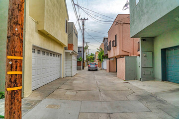 Car on a narrow neighborhood street along houses in Long Beach California