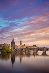 Obraz premium Charles Bridge during beautiful romantic colorful spring summer golden hour before sunset with wonderful blue sky with clouds, Czechia, Europe